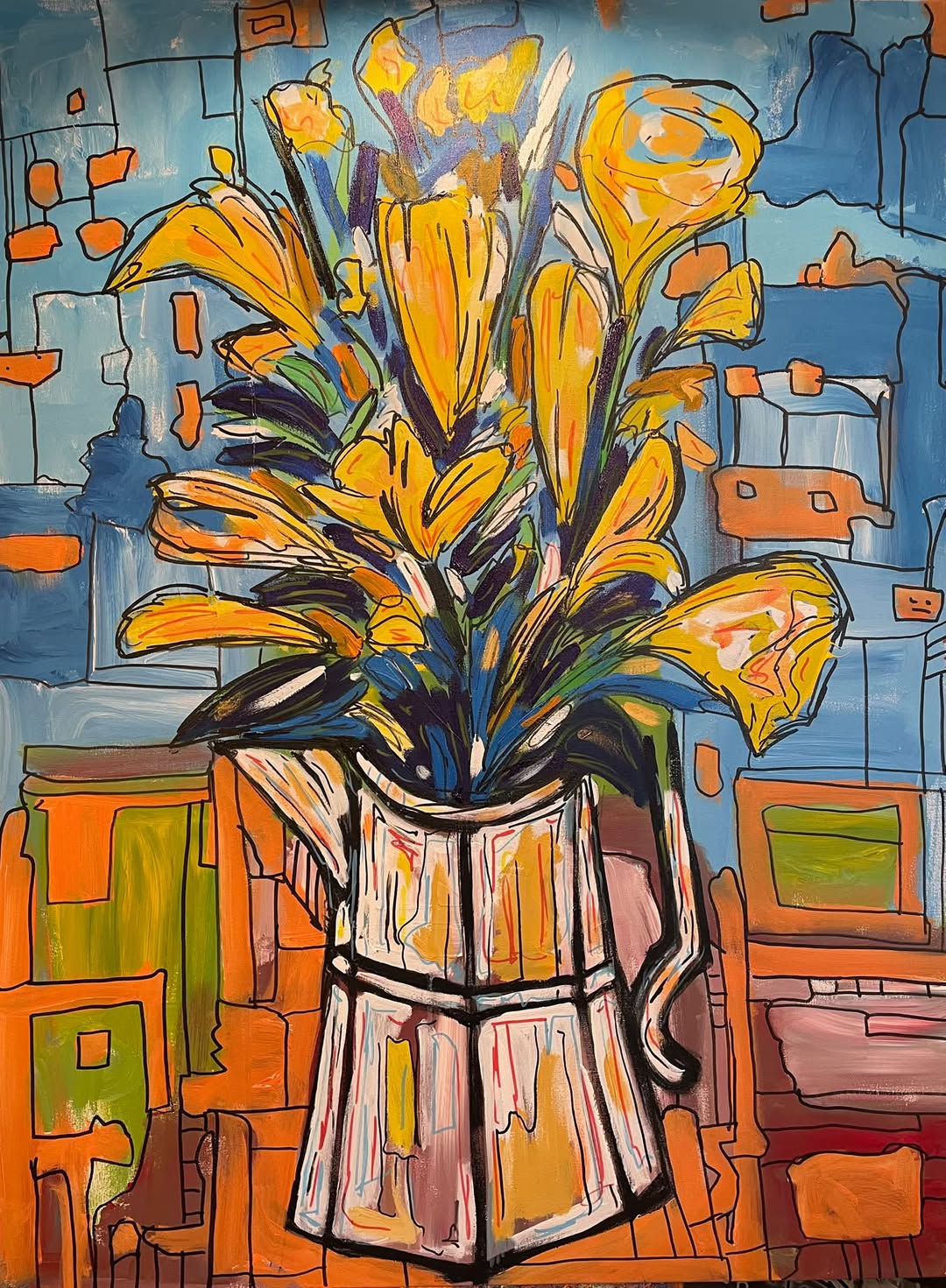 Yellow flowers in a faceted pitcher against a blue and orange geometric background