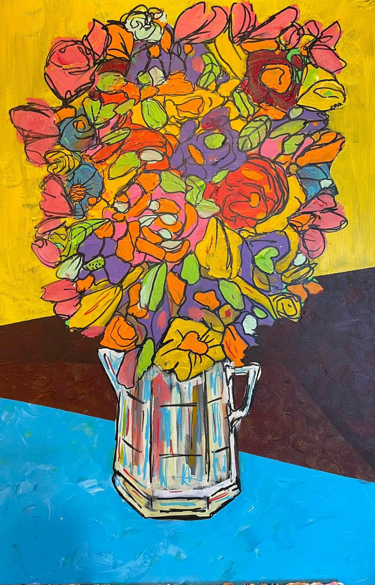 Colorful bouquet of flowers in a faceted pitcher resting on a table