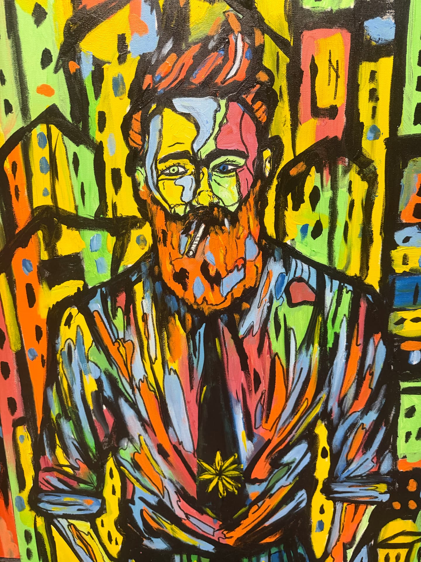 Portrait of a red-bearded man smoking against bold yellow, orange and green